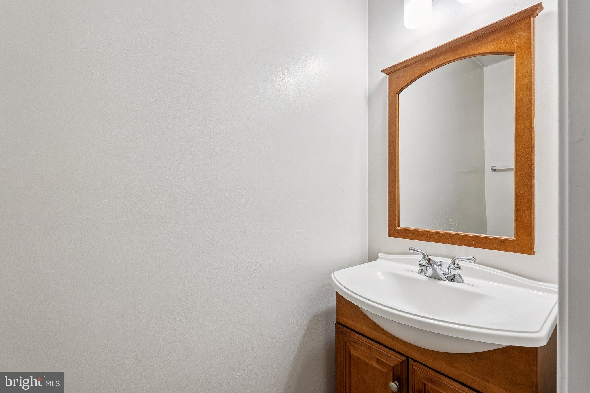 2343 Glade Bank Way Reston, VA 20191 - Photo 27 of 38 a bathroom with a sink and a mirror