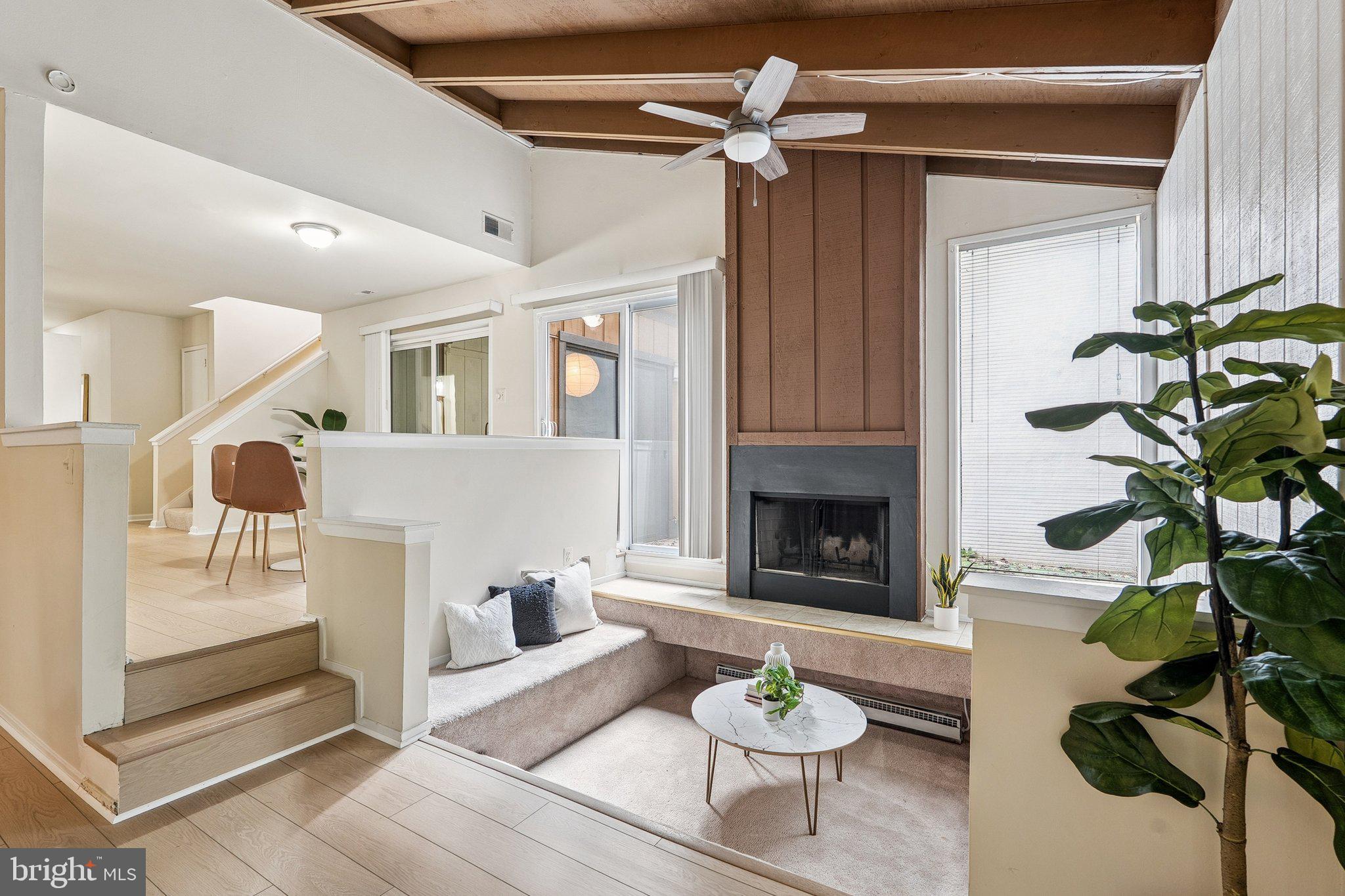 2343 Glade Bank Way Reston, VA 20191 - Photo 6 of 38 a living room with furniture a fireplace and a table