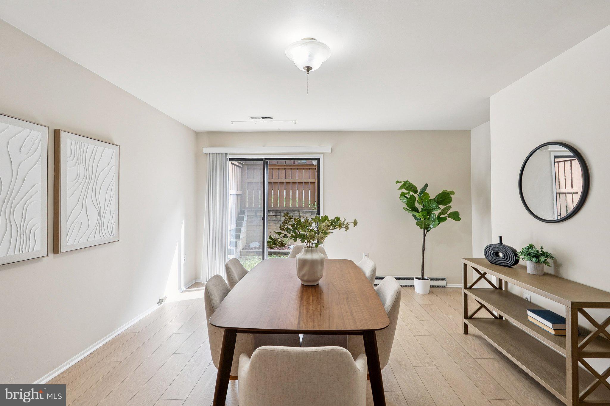 2343 Glade Bank Way Reston, VA 20191 - Photo 7 of 38 a view of a dining room with furniture and a potted plant