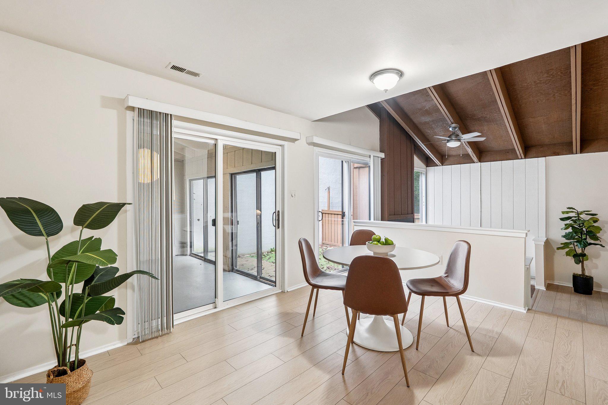 2343 Glade Bank Way Reston, VA 20191 - Photo 8 of 38 a view of a dining room with furniture and a potted plant