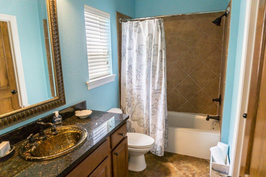 4554 Biscayne Way Destin, FL 32541 - Photo 21 of 33 a bathroom with a sink a toilet and shower
