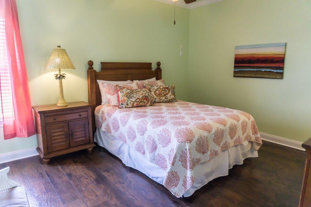 4554 Biscayne Way Destin, FL 32541 - Photo 24 of 33 a large bed sitting in a bedroom next to a lamp