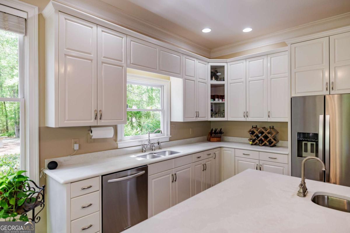835 Timothy Road Athens, GA 30606 - Photo 16 of 65 a kitchen with a sink a window and stainless steel appliances