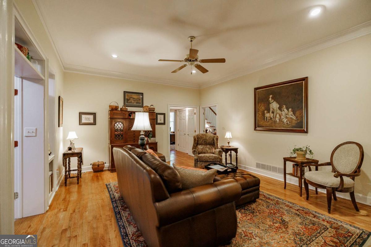 835 Timothy Road Athens, GA 30606 - Photo 25 of 65 a living room with furniture a flat screen tv and a wooden floor