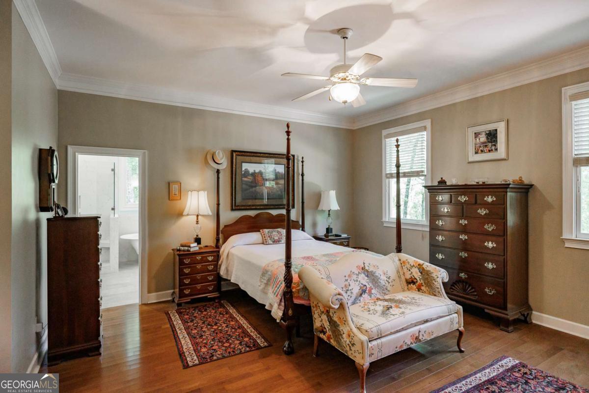 835 Timothy Road Athens, GA 30606 - Photo 34 of 65 a bedroom with a bed and wooden floor