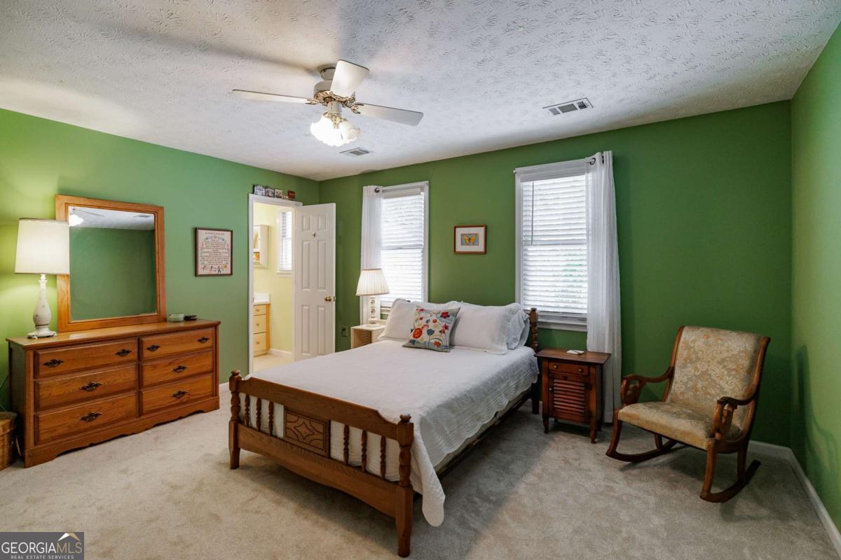 835 Timothy Road Athens, GA 30606 - Photo 42 of 65 a bedroom with a bed and a chandelier