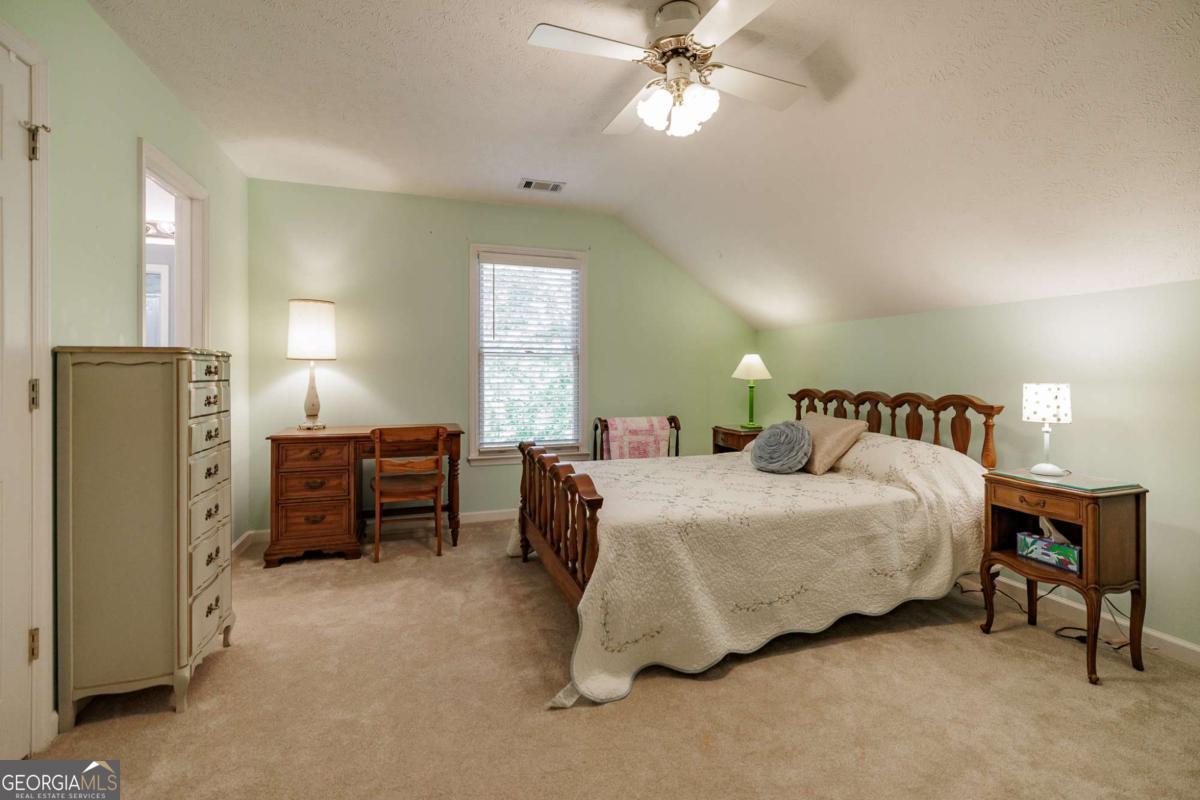 835 Timothy Road Athens, GA 30606 - Photo 48 of 65 a spacious bedroom with a bed and a chandelier