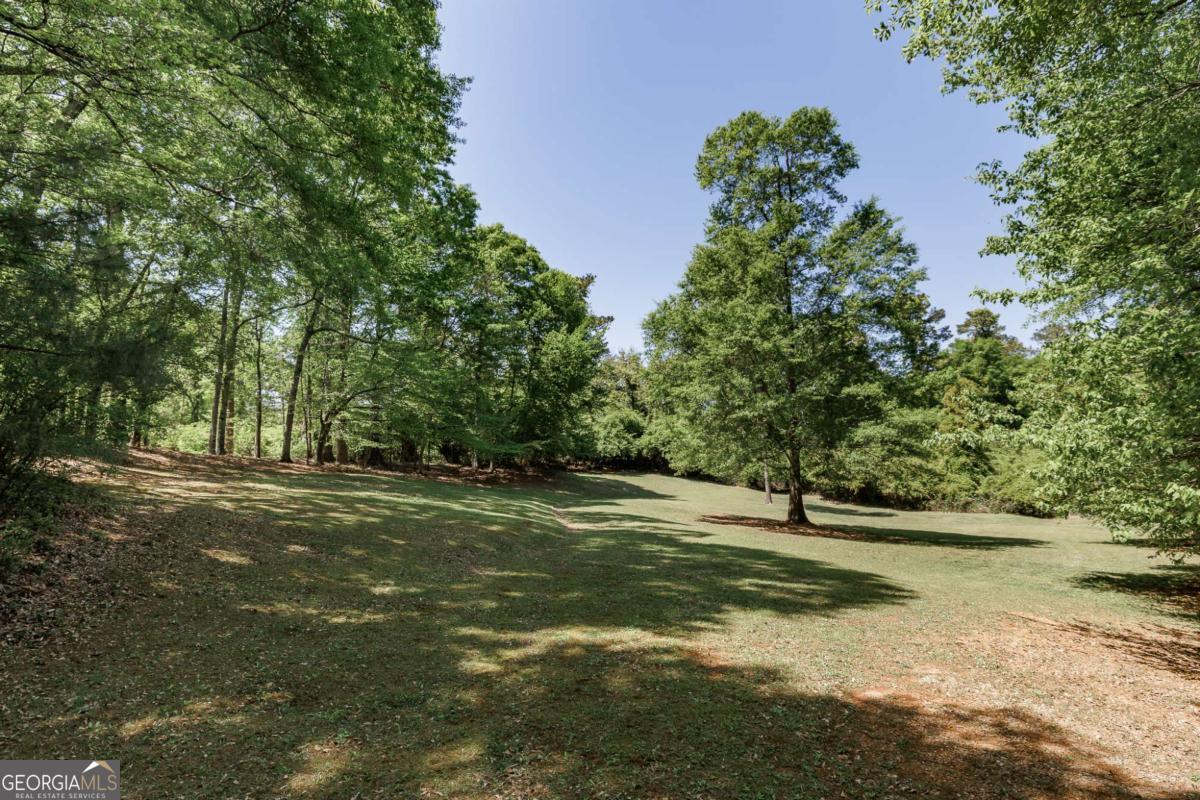 835 Timothy Road Athens, GA 30606 - Photo 54 of 65 a view of a field with trees in the background
