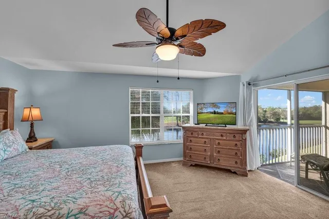 a bedroom with a bed and large window