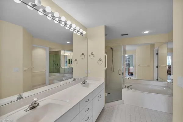 a spacious bathroom with a double vanity sink mirror double and shower