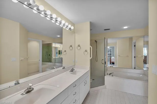 a spacious bathroom with a double vanity sink mirror double and shower