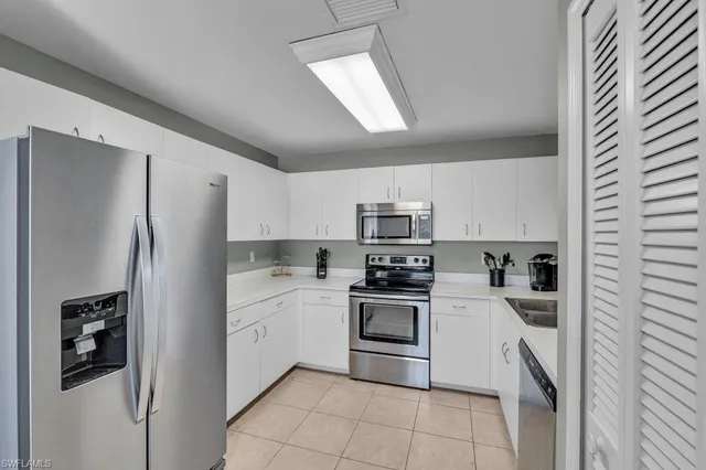 a kitchen with stainless steel appliances a refrigerator sink and stove