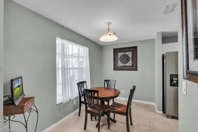 a view of a dining room with furniture and a window