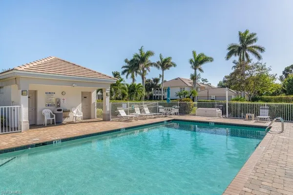 a view of a house with a yard patio and swimming pool