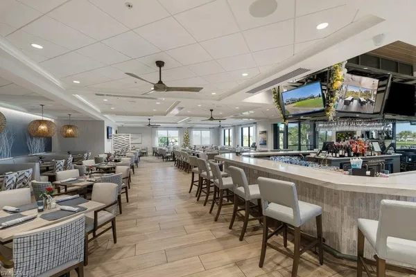 a room with lots of furniture and a view of a chandelier