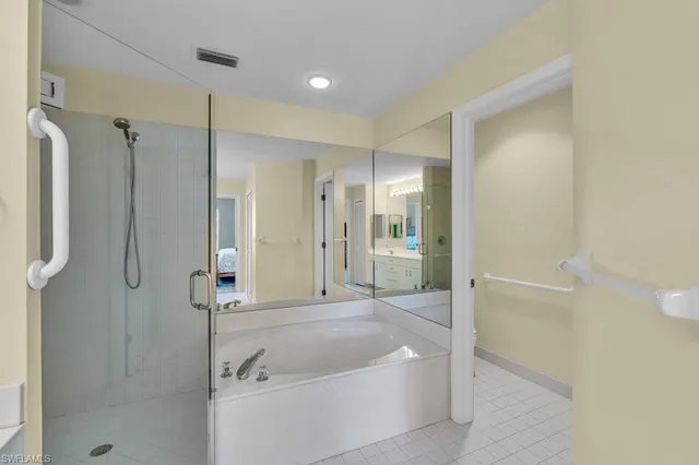 a bathroom with a tub shower and sink