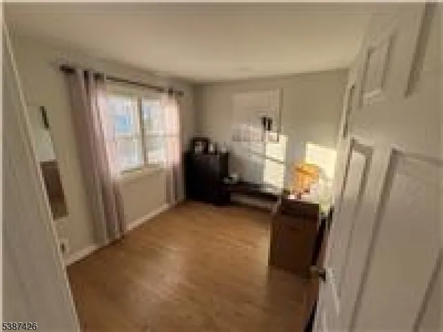 a view of a room with window refrigerator and window