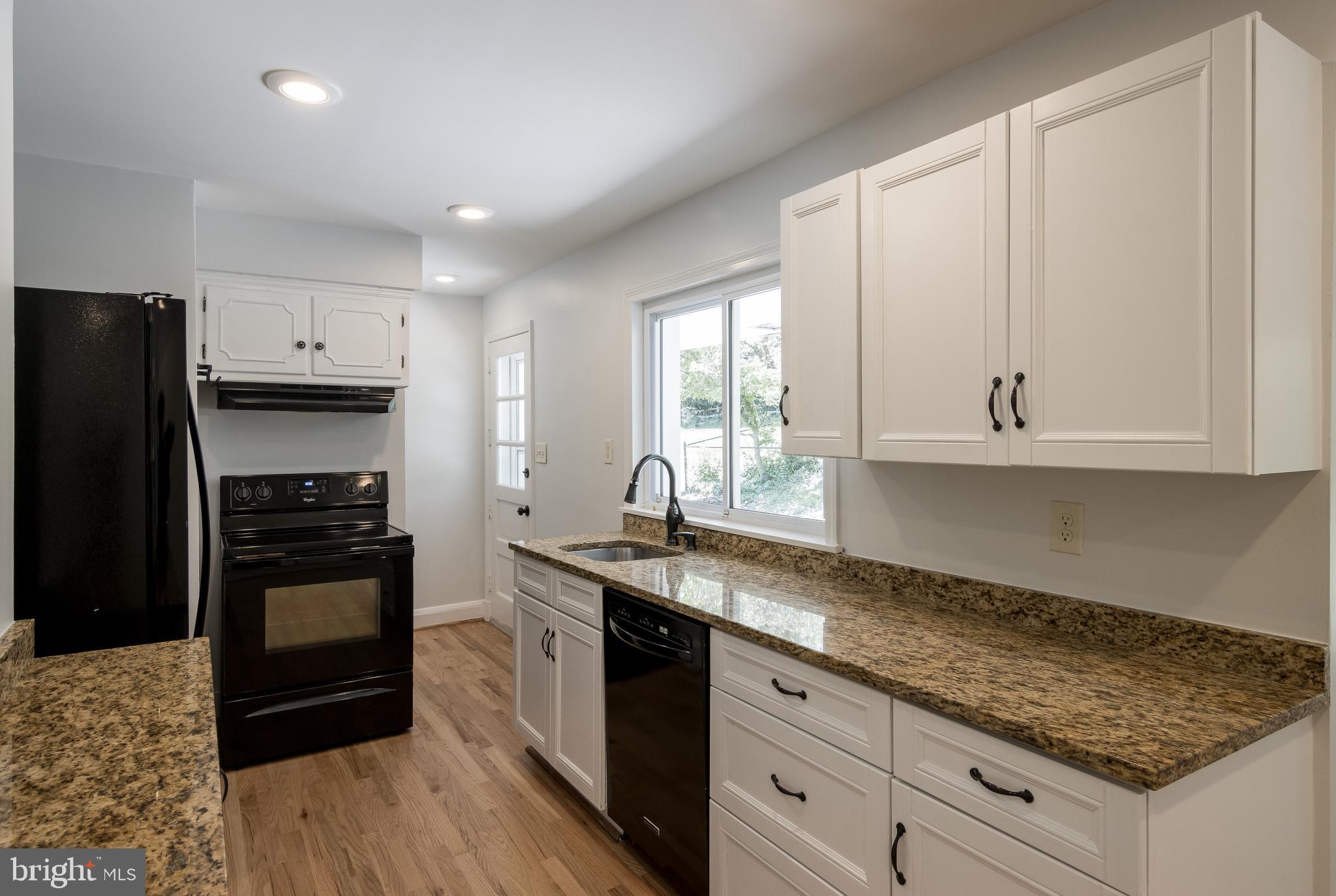 1206 Culvert Road Baltimore, MD 21286 - Photo 13 of 46 Granite Kitchen with White Wood Cabinets