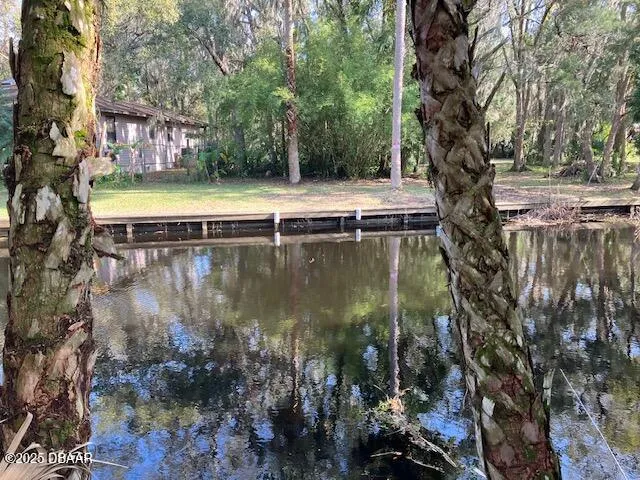 a view of a lake with a house in the background
