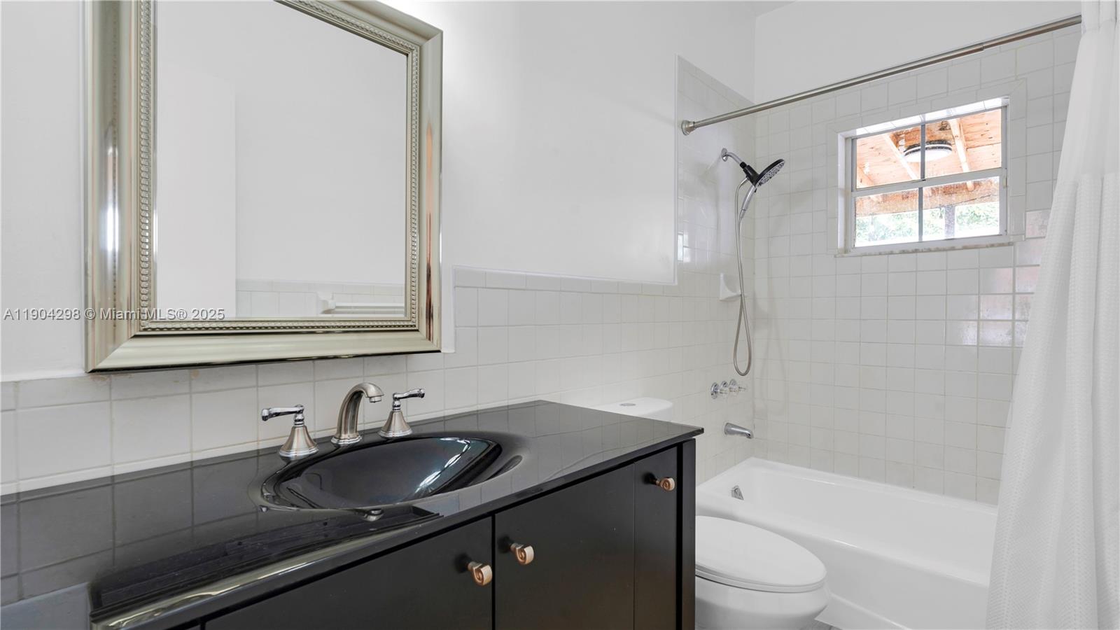 2271 Southwest 25th Street, Unit 2271 Miami, FL 33133 - Photo 18 of 39 a bathroom with a granite countertop sink toilet and shower