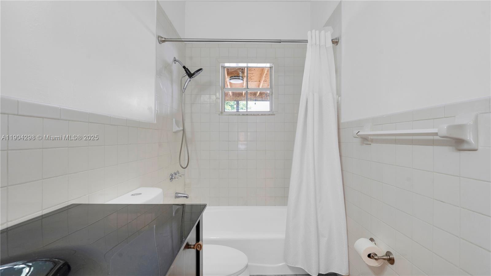 2271 Southwest 25th Street, Unit 2271 Miami, FL 33133 - Photo 19 of 39 a bathroom with a bathtub and a shower