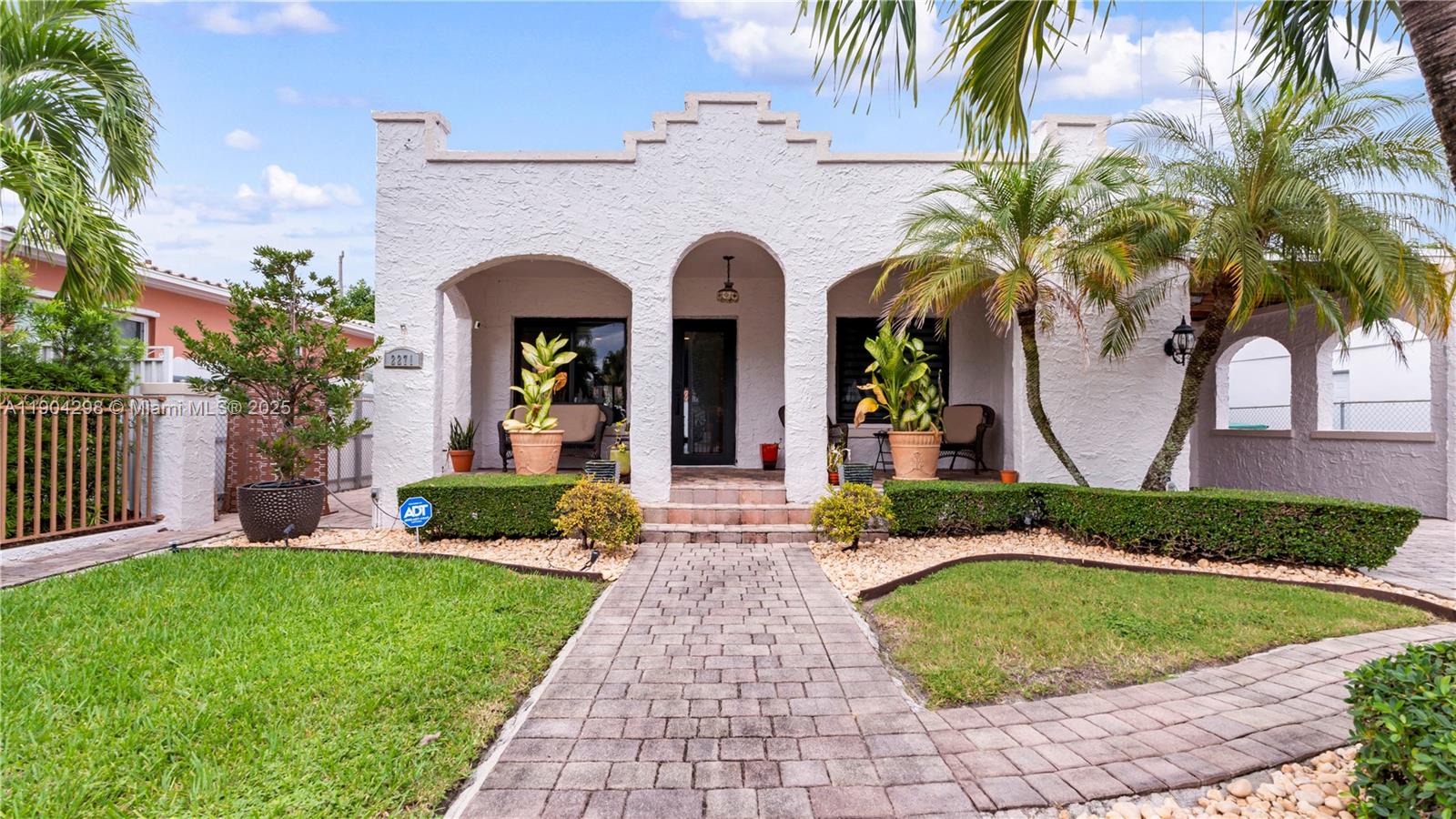 2271 Southwest 25th Street, Unit 2271 Miami, FL 33133 - Photo 2 of 39 a front view of a house with garden