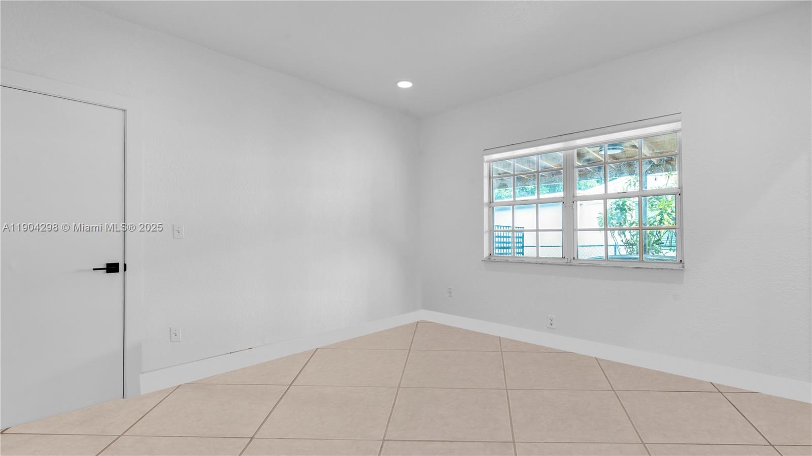 2271 Southwest 25th Street, Unit 2271 Miami, FL 33133 - Photo 23 of 39 a view of an empty room with a window