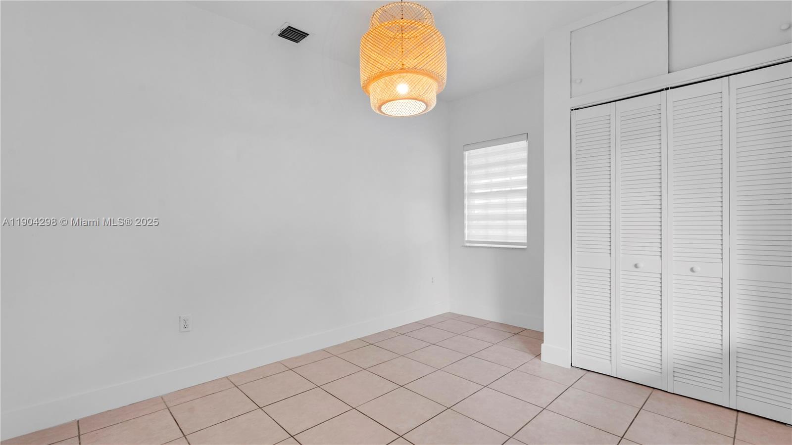 2271 Southwest 25th Street, Unit 2271 Miami, FL 33133 - Photo 27 of 39 an empty room with windows