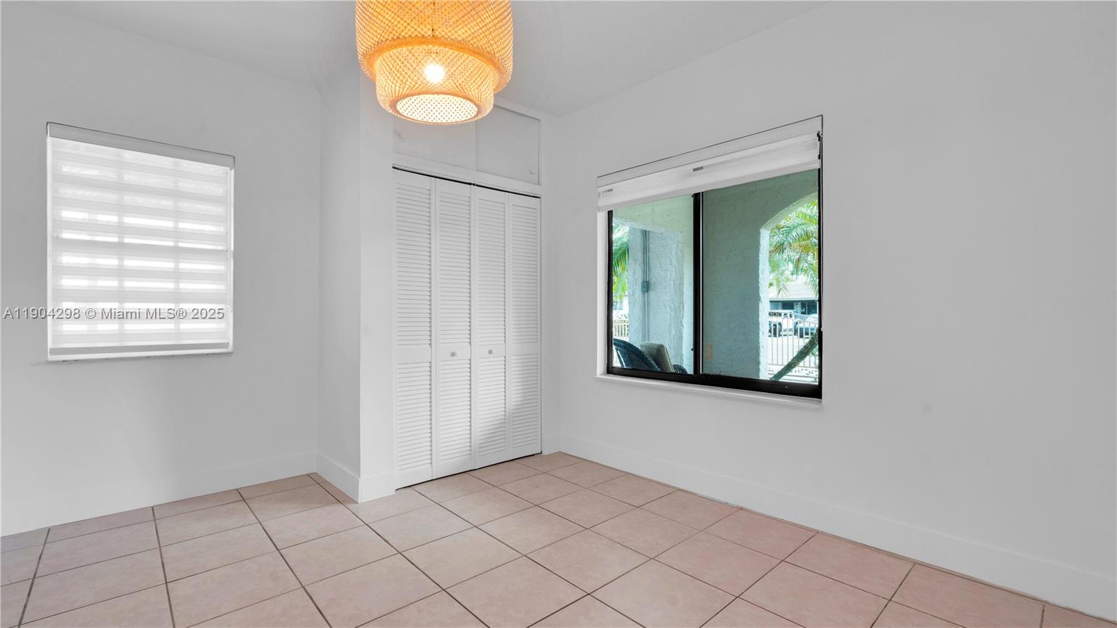 2271 Southwest 25th Street, Unit 2271 Miami, FL 33133 - Photo 28 of 39 an empty room with window and mirror