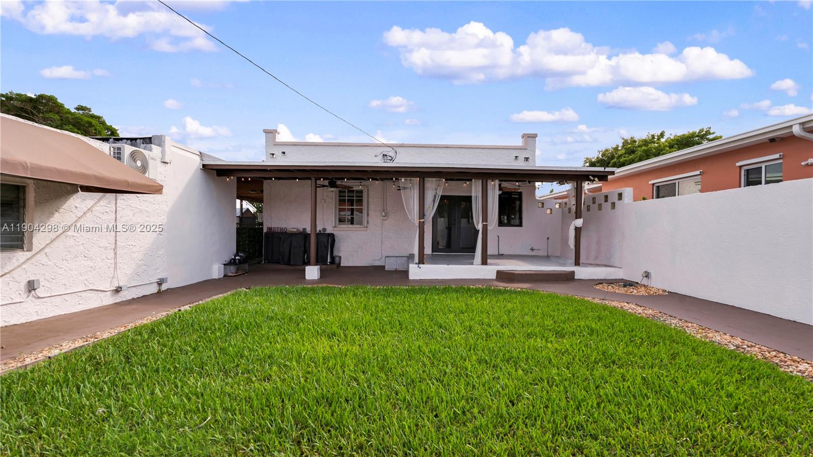 2271 Southwest 25th Street, Unit 2271 Miami, FL 33133 - Photo 35 of 39 a view of a house with a backyard and porch