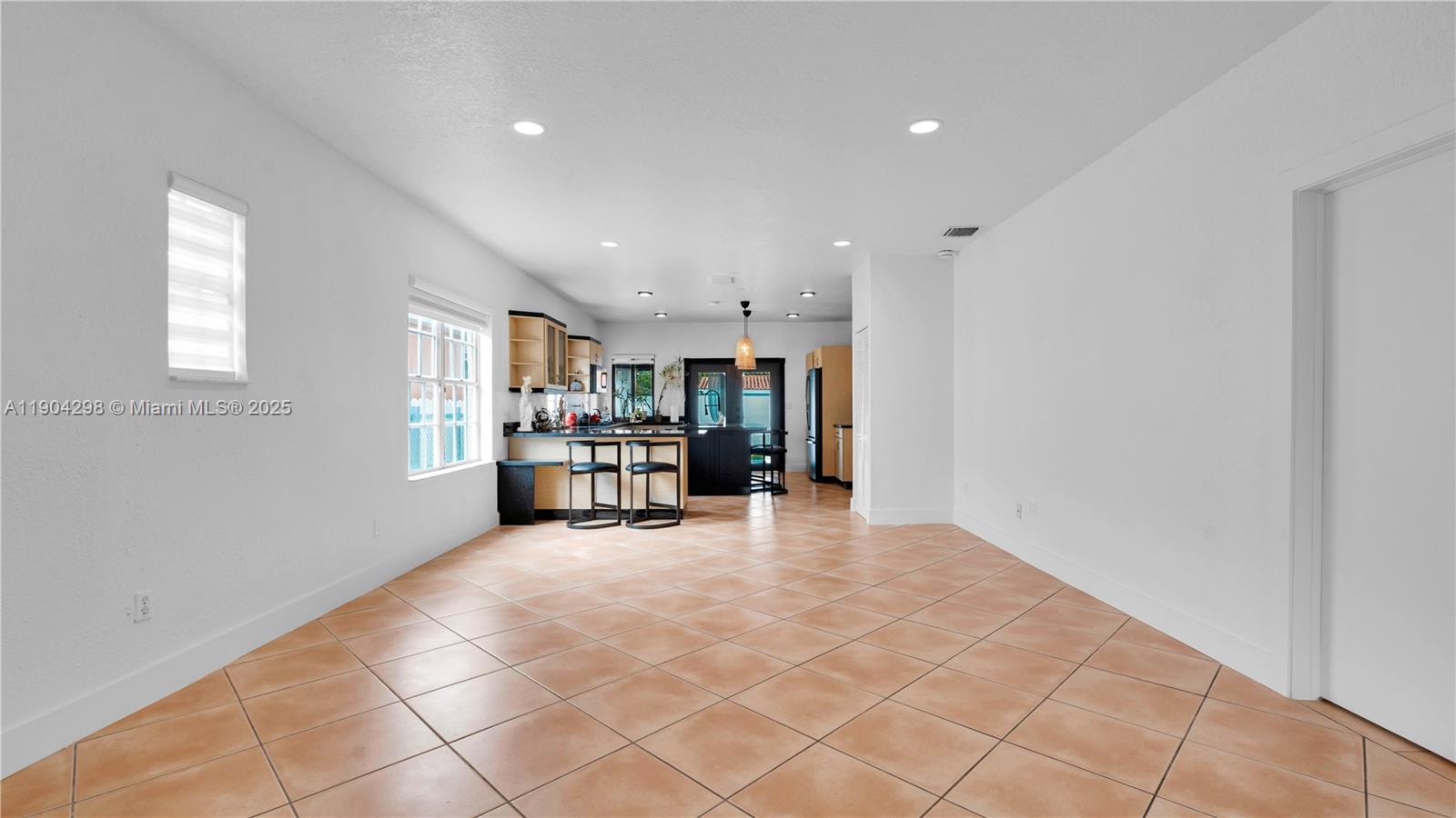 2271 Southwest 25th Street, Unit 2271 Miami, FL 33133 - Photo 8 of 39 a view of a livingroom with kitchen and furniture