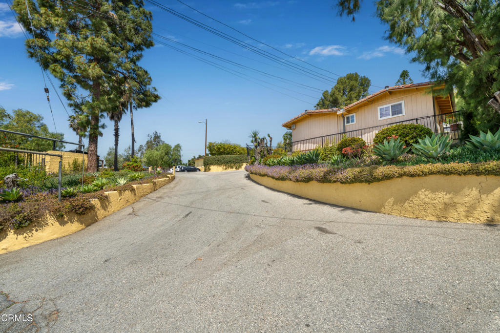 65 Wicks Road Moorpark, CA 93021 - Photo 14 of 21 a front view of a house with a yard and a garage
