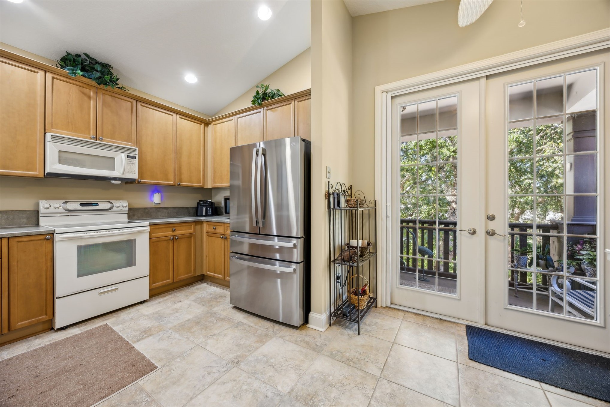 1839 Perimeter Park Road West, Unit 210 Fernandina Beach, FL 32034 - Photo 9 of 37 a kitchen with stainless steel appliances a refrigerator sink and cabinets