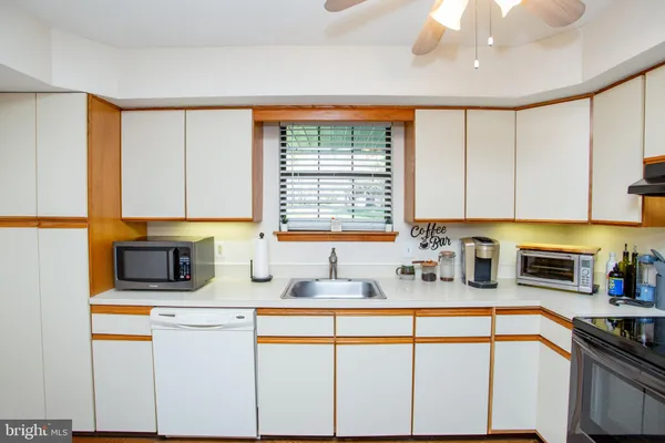 a kitchen with stainless steel appliances granite countertop a sink a stove and cabinets