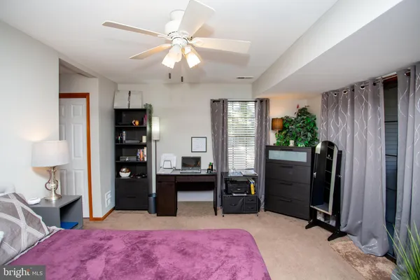 a bedroom with a bed dresser and a window