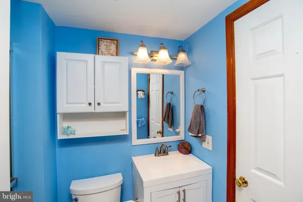 a bathroom with a sink vanity and a mirror