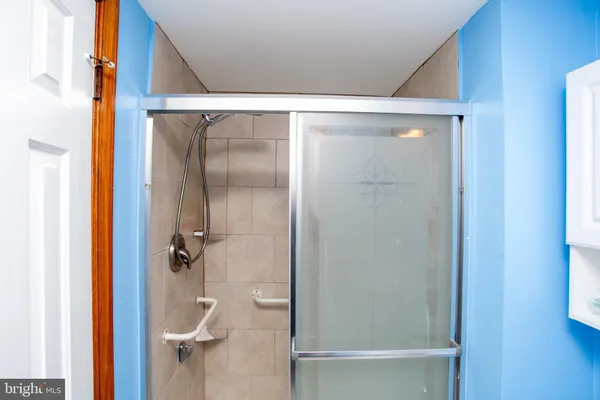a bathroom with a glass shower door