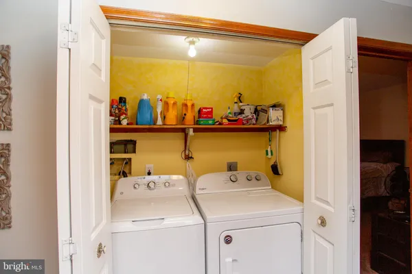 a view of storage and utility room with washer and dryer