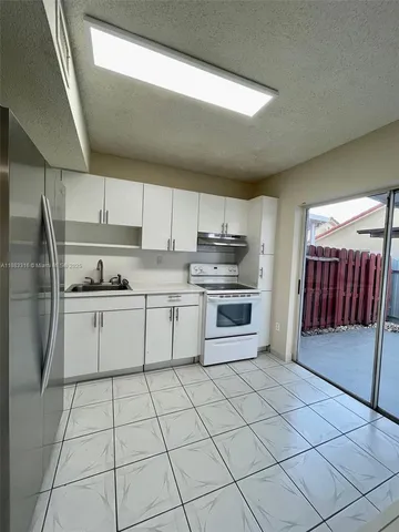 a kitchen with stainless steel appliances cabinets a sink and a stove