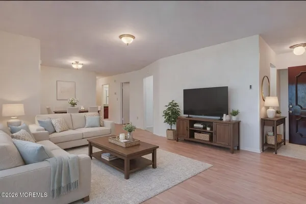 a living room with furniture and a flat screen tv