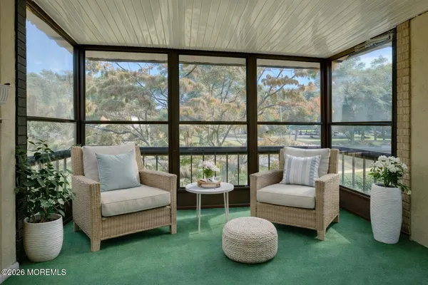 a living room with furniture and a floor to ceiling window