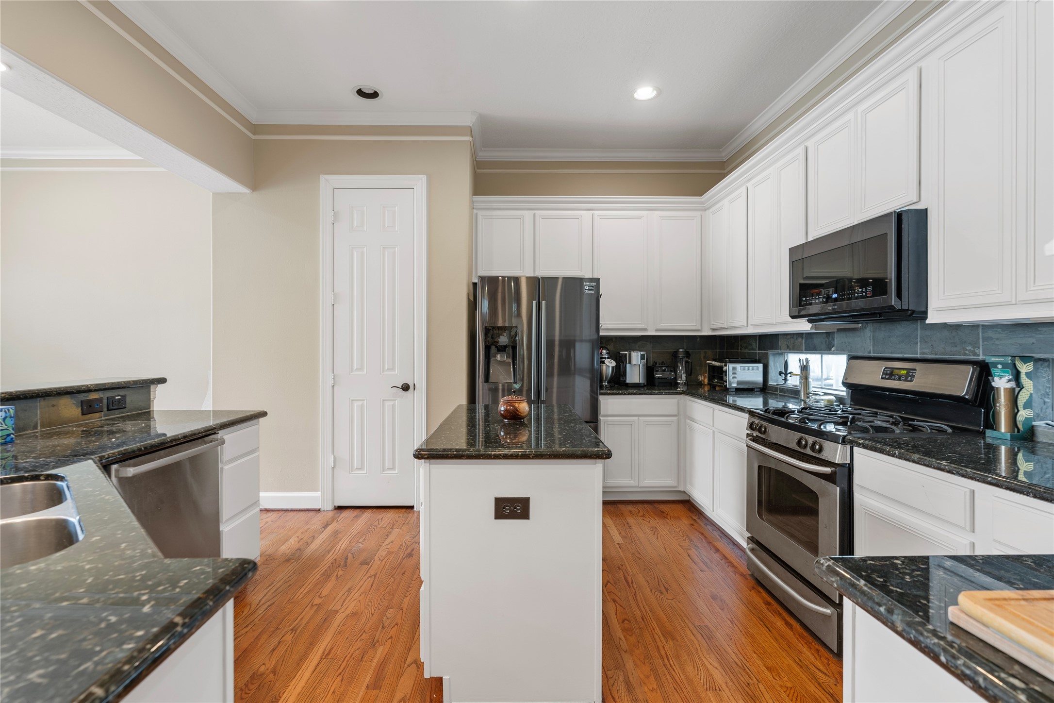 408 Fowler Street Houston, TX 77007 - Photo 11 of 24 A closer look at the kitchen reveals ample counter space, gas cooking, stainless steel appliances, and generous pantry storage.