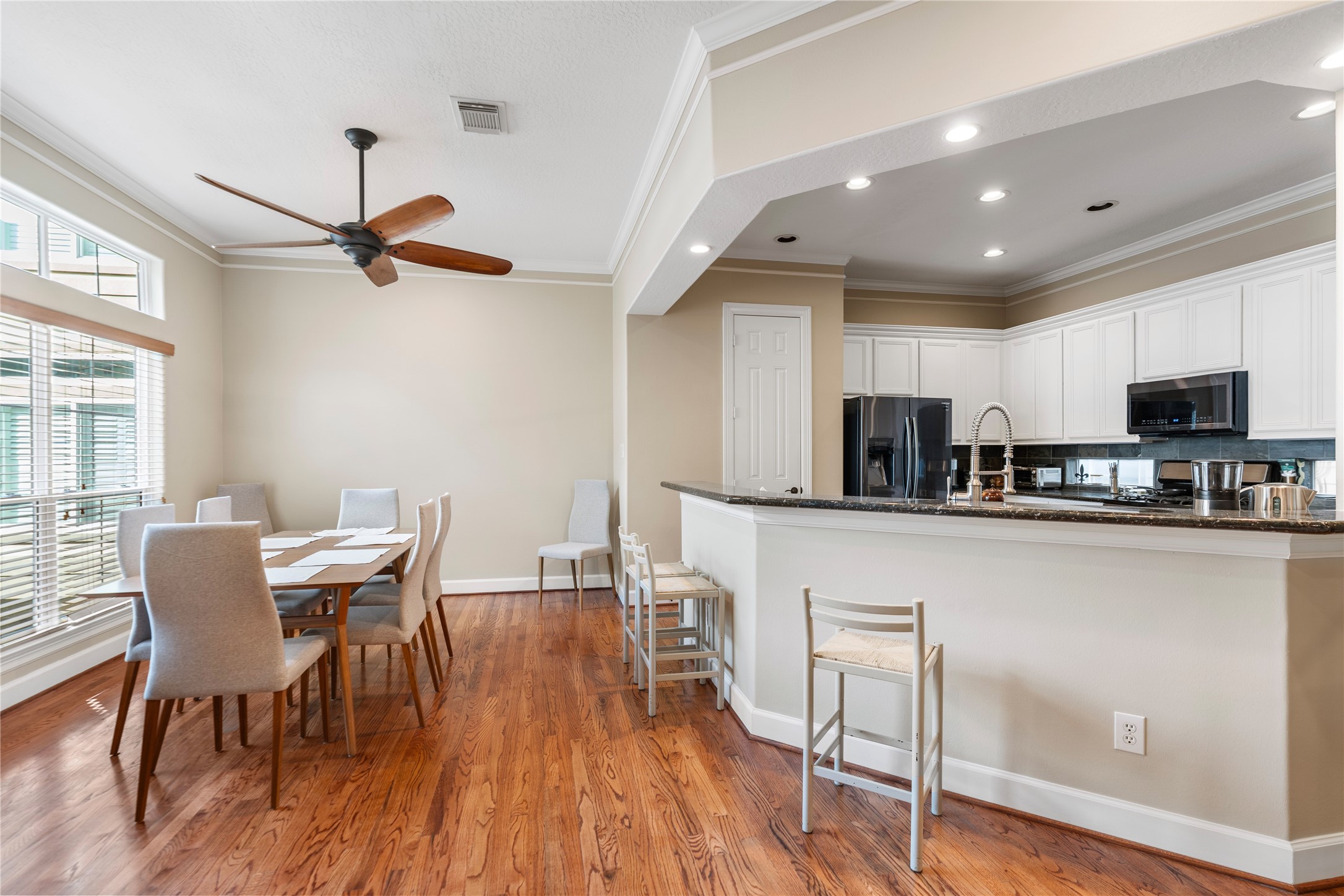 408 Fowler Street Houston, TX 77007 - Photo 12 of 24 The open-concept layout features a bright dining area and a convenient breakfast bar—perfect for casual meals or entertaining guests.
