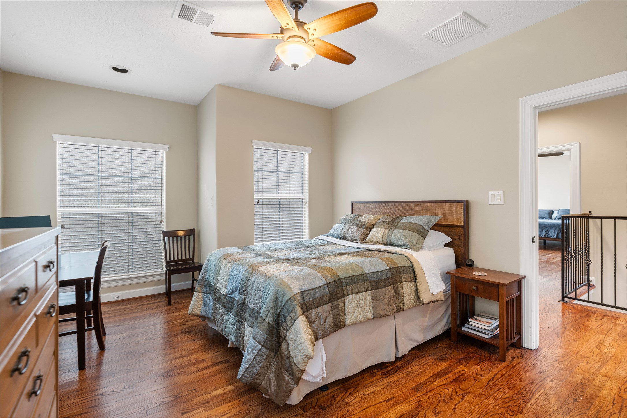 408 Fowler Street Houston, TX 77007 - Photo 20 of 24 Generously sized bedroom with hardwood flooring and natural light—ideal as a guest suite or home office.