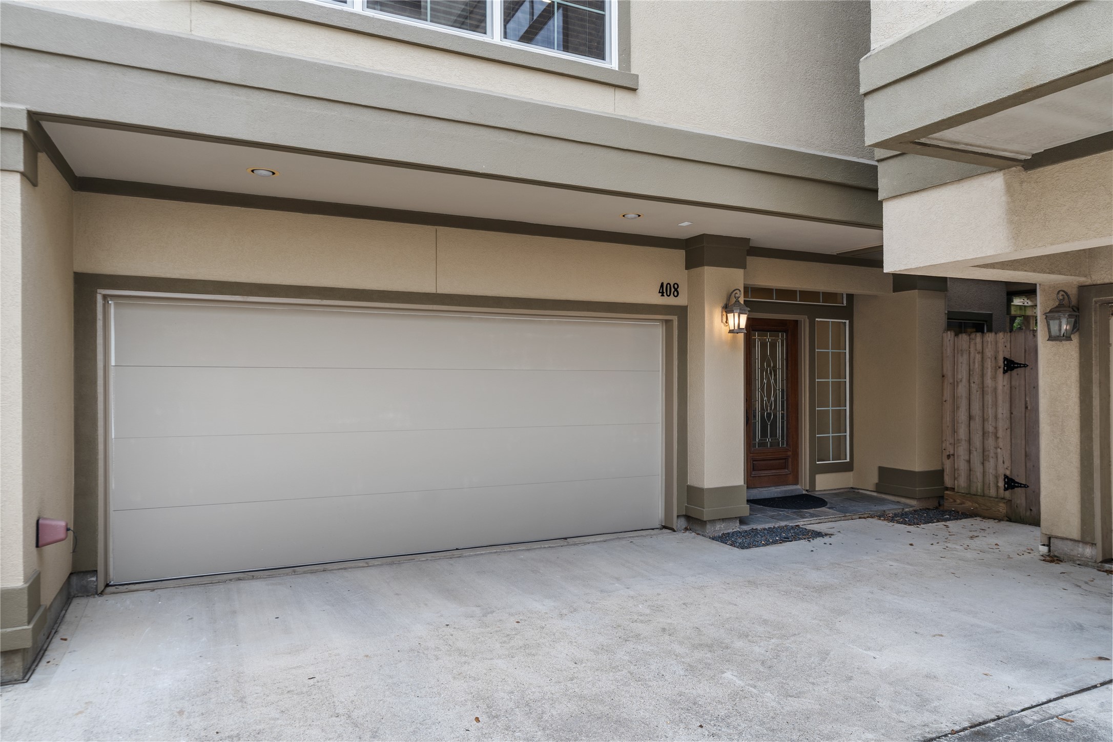 408 Fowler Street Houston, TX 77007 - Photo 22 of 24 Spacious two-car garage with a welcoming front entry and covered access—offering both function and curb appeal.