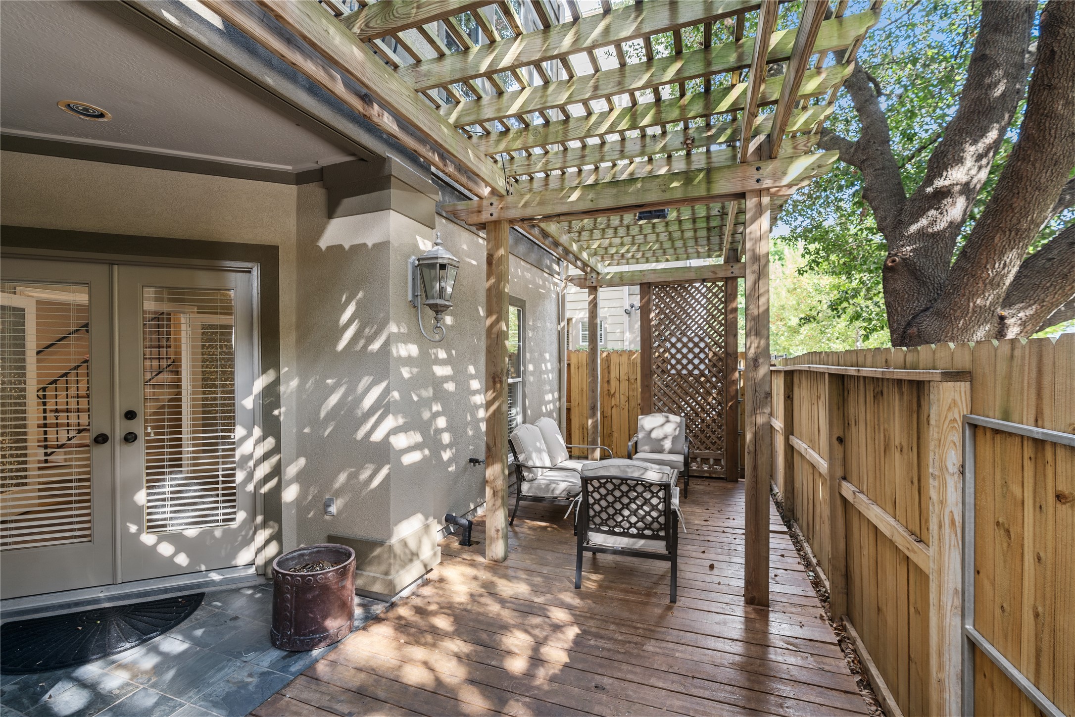 408 Fowler Street Houston, TX 77007 - Photo 5 of 24 Enjoy outdoor living on this generous wood deck, complete with new fencing and overhead pergola—ideal for relaxing or entertaining.