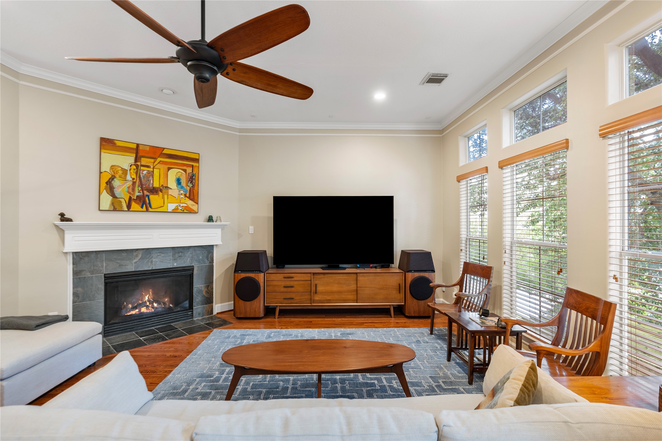 408 Fowler Street Houston, TX 77007 - Photo 8 of 24 The living room centers around a slate-accented gas fireplace and a wall of windows that fill the space with natural light.