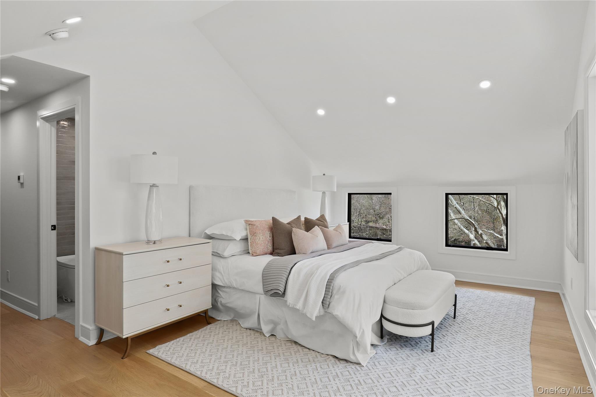 39 Old Snake Hill Road Pound Ridge, NY 10576 - Photo 15 of 37 a bedroom with a white bed and dresser