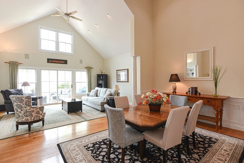 4 Williams Road, Unit 4 Norton, MA 02766 - Photo 12 of 41 a dining room with wooden floor a chandelier fan a glass table and windows