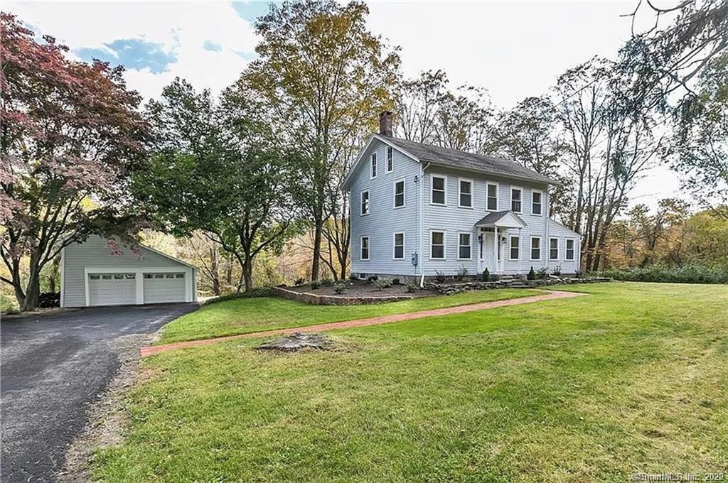 358 Ridgefield Road Wilton, CT 06897 - Photo 1 of 1 a view of a house with a big yard and large trees